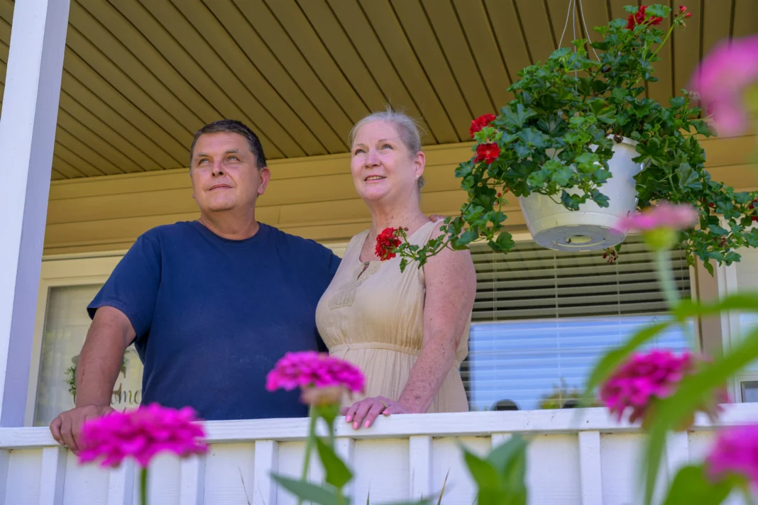 Charlie and Amye Joseph stand on their porch.